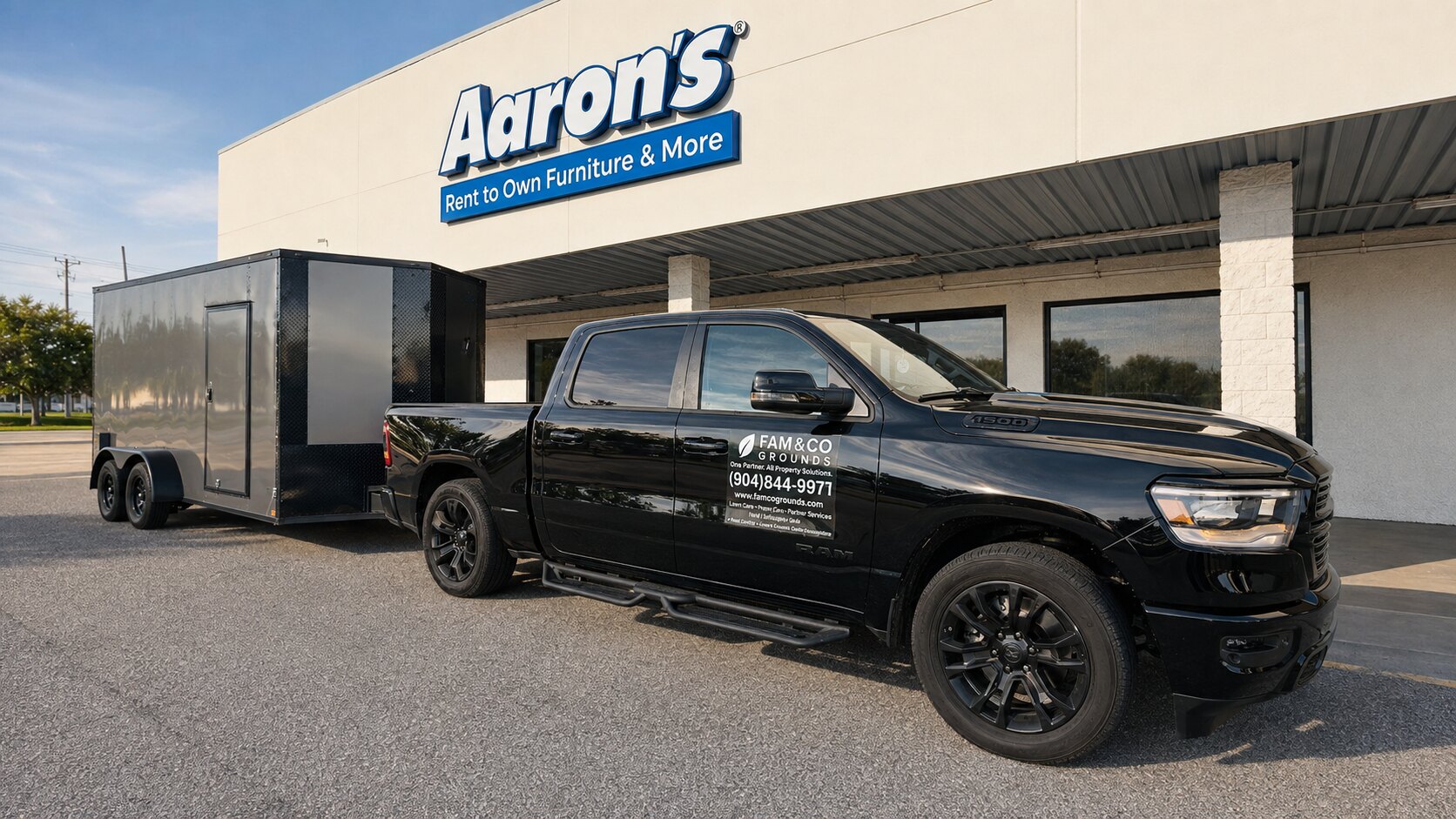 Fam&Co Grounds branded truck and enclosed service trailer at a commercial property