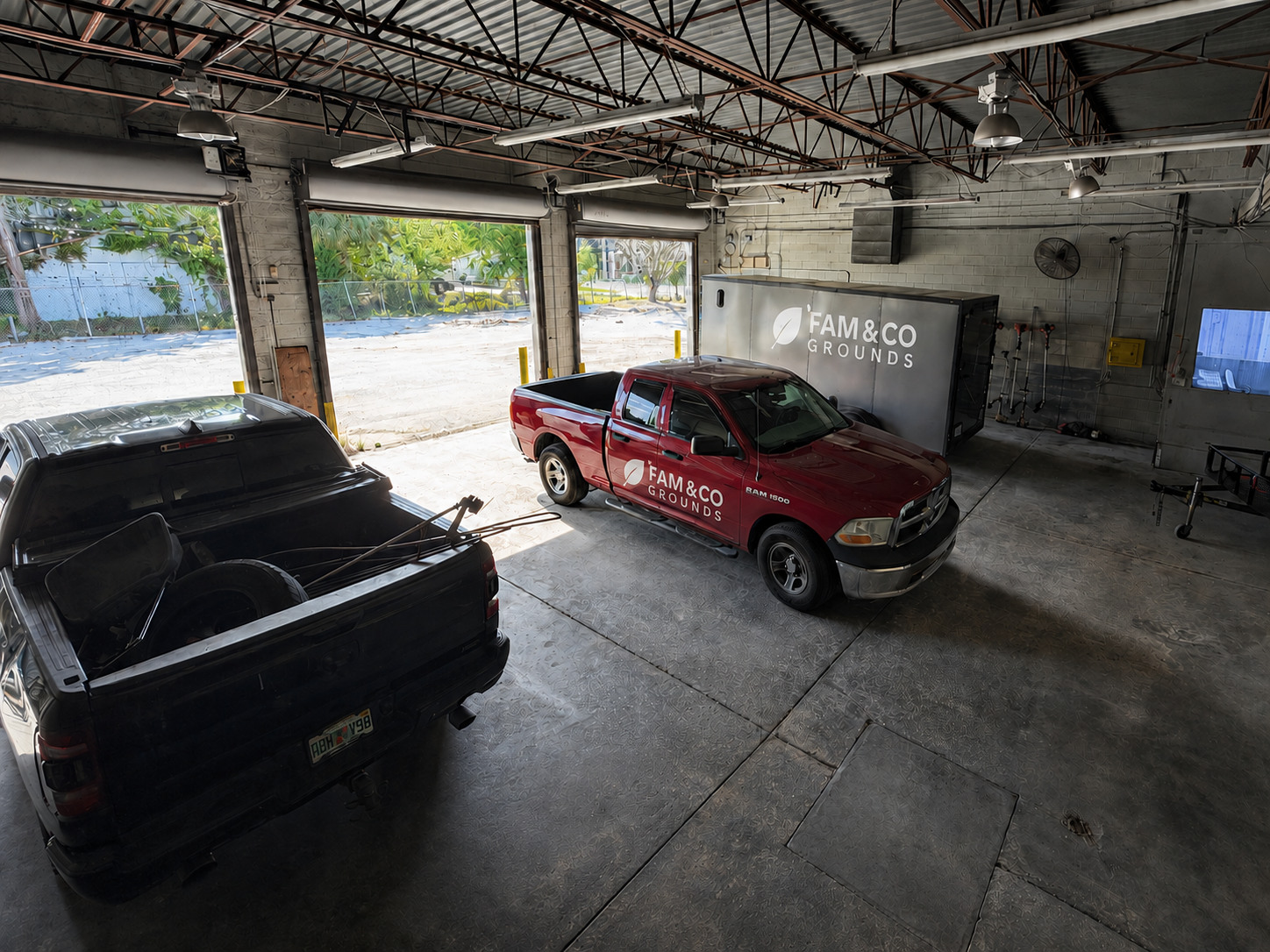 Fam&Co vehicles and enclosed service trailer organized inside the local operations facility